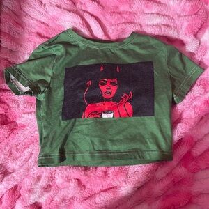 Green top with devil on it